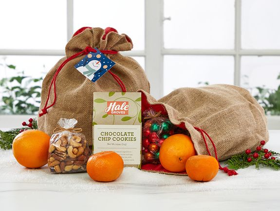2 Navel Oranges, 2 Tangerines, 4 Small Cara Cara Navel Oranges, 3 oz. Chocolate Chip Cookies, 1 Crispy Treat Snowman, 2 oz. Mixed Nuts, Burlap Gift bag and tag